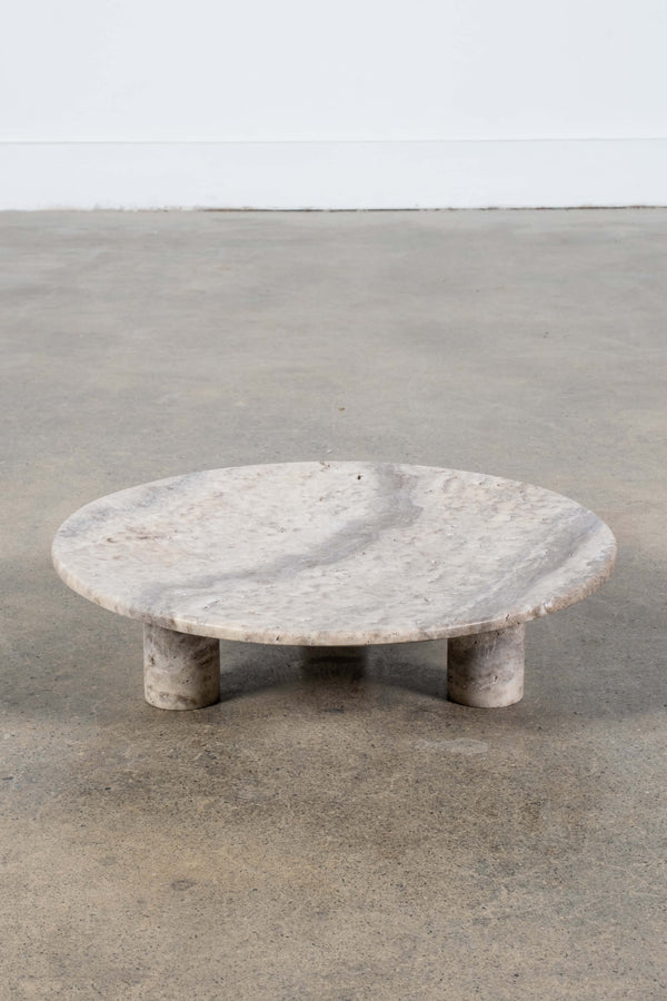 Round Footed Plate in Grey Travertine, front angled view
